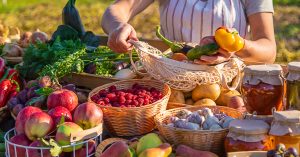 A woman farmer sells fruits and vegetables at a farmers market. Selective focus. Food.